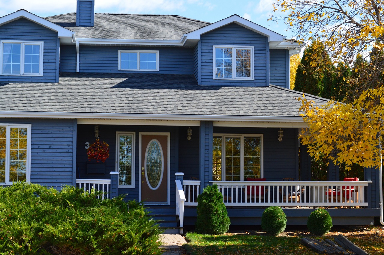 Blue two-story house with white trim and a front porch
